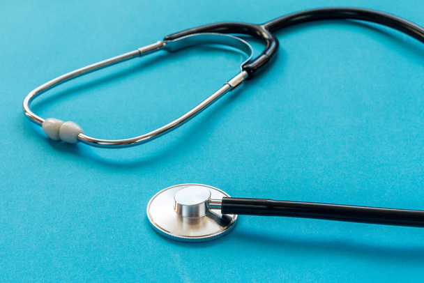 Medical stethoscope on a blue background close up. - Fotoğraf, Görsel