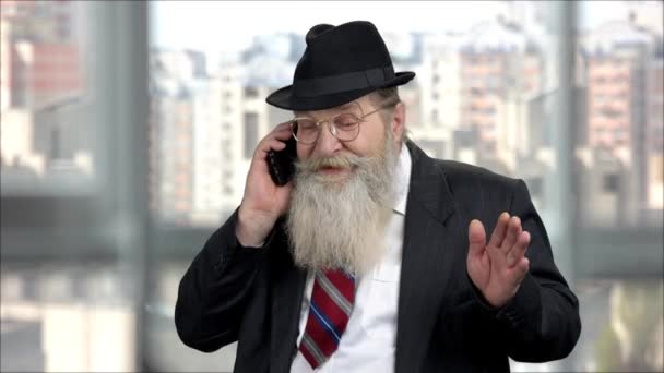 Old senior long-bearded businessman talking on phone. - Footage, Video