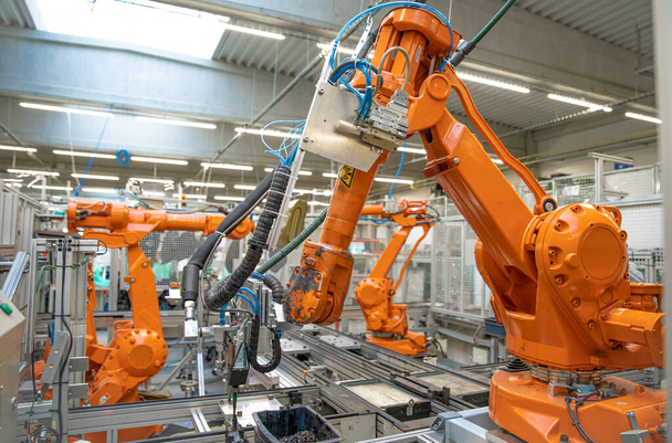orange robot arms on the production line. controlled by a computer with artificial intelligence - Photo, Image