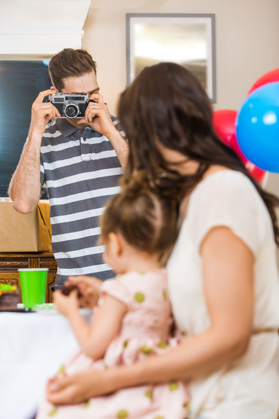 Man Taking Picture Of Family At Birthday Party - Photo, image