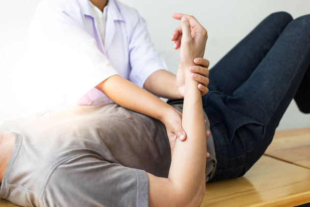Professional therapists are stretching muscles, patients with abnormal muscular symptoms, physical rehabilitation therapies and treatment of physiological disorders by physiotherapists concept. - Photo, Image