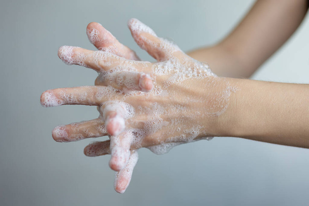 Washing hands with foamy soap, protection against coronavirus. Close up - Foto, imagen