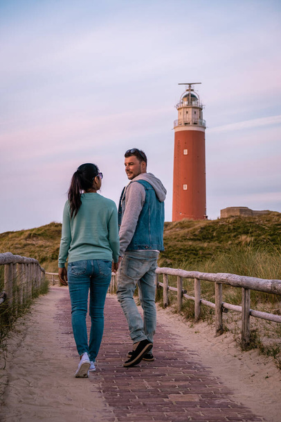 Texel lighthouse during sunset Netherlands Dutch Island Texel, couple visit the lighthouse , men and woman on vacation Texel - Valokuva, kuva