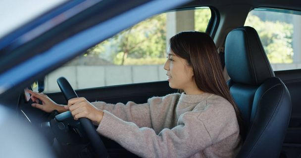 Woman set gps location on cellphone inside a car - Photo, Image