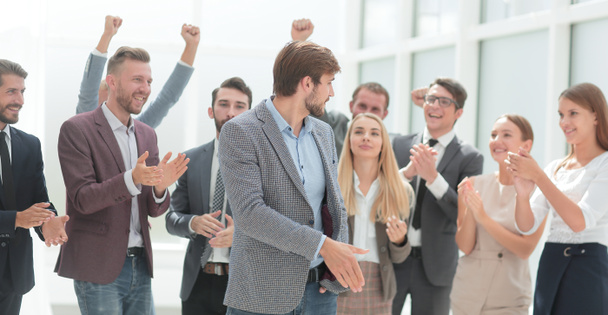 cheerful employees congratulating a colleague on the promotion - Foto, imagen
