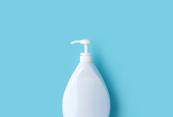 Big bottle of hand sanitizer or soap on blue background. Medical health protection concept. - Fotoğraf, Görsel