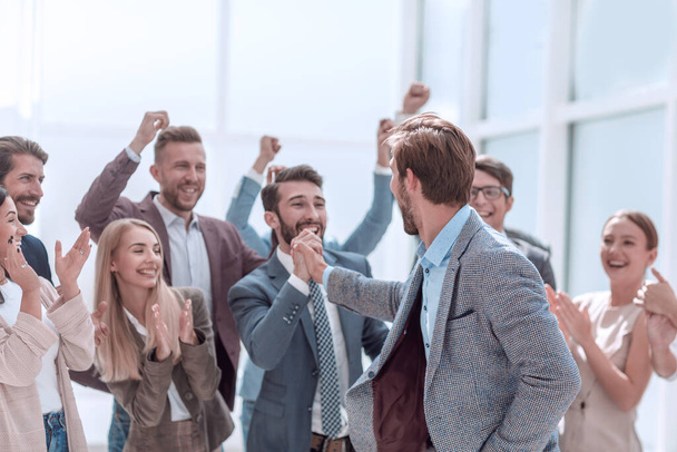 empleados alegres felicitando a un colega por la promoción - Foto, imagen