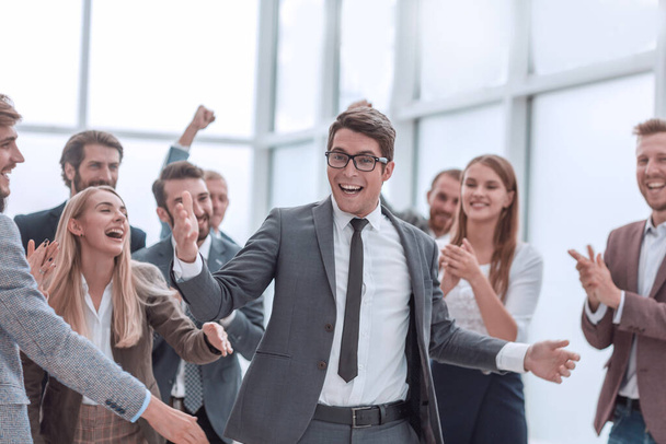 happy young businessman standing in front of his business team. - Foto, imagen