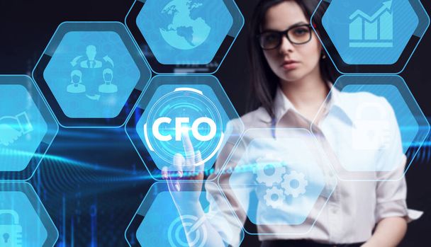 Business, Technology, Internet and network concept. Young businessman working on a virtual screen of the future and sees the inscription: CFO - Photo, Image