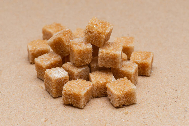 brown refined sugar cubes on craft paper background - Foto, Imagen