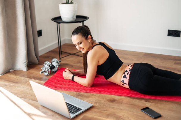 Woman doing fitness at home with video tutorial - Fotografie, Obrázek