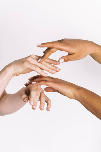 multiracial hands holding on white background  - Zdjęcie, obraz