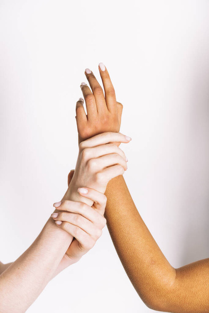 multiracial hands holding on white background  - Фото, изображение