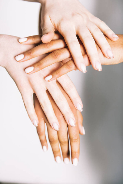multiracial hands holding on white background  - Foto, Imagen
