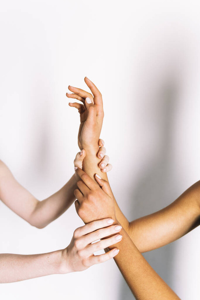 multiracial hands holding on white background  - Foto, afbeelding
