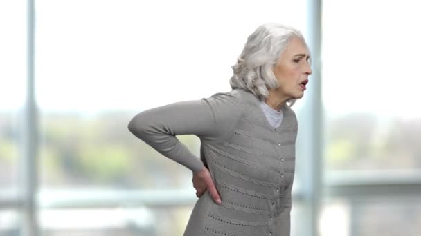 Öreg vékony nő szenved a hátfájás. - Felvétel, videó