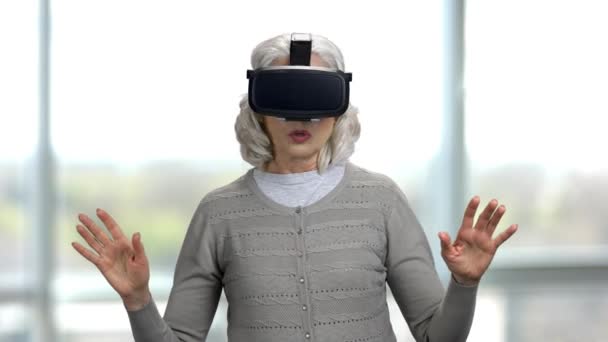 Old lady shocked experiencing virtual reality headset. - Footage, Video