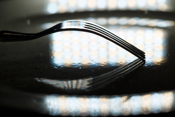 Metal forks and knives on a plate - Foto, imagen