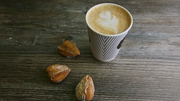 man hand put second latte cup next to another and almond cookies - Felvétel, videó