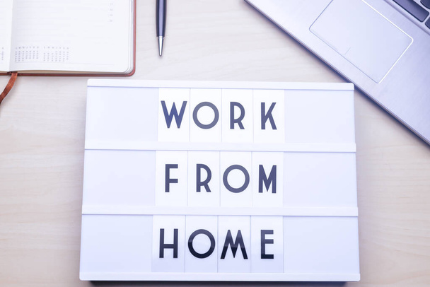 Work from home. Workspace table with a lichtbox with the words WORK FROM HOME. - Foto, Imagem