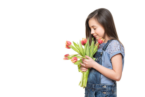 Adorable little girl holding bouquet of pink tulips against white background. Happy Mother's Day, Women's day, Father's day or Birthday concept. - Photo, Image