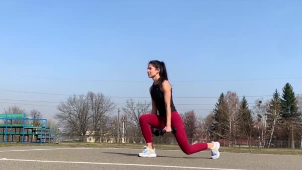 Woman Sports Training And Working Out Outdoor At Morning. Strong and sporty woman doing lunges, squat, burpee - Footage, Video