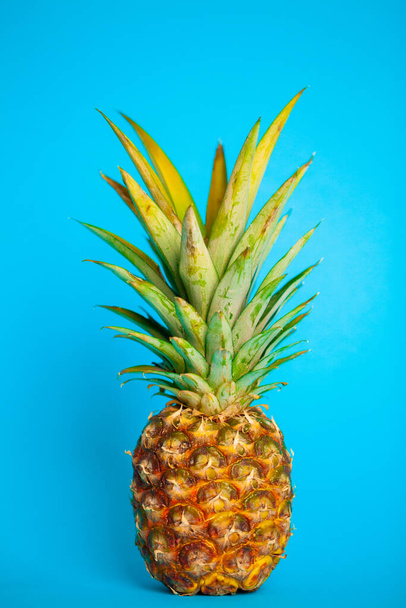 Fresh ripe pineapple on a blue background - Photo, Image