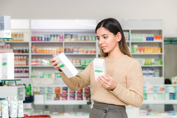 woman choosing vitamins and supplements for immune system. coronavirus pandemic necessity. - Photo, Image
