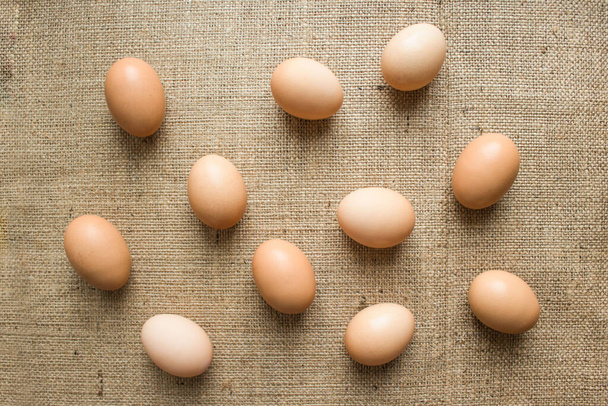 Fresh organic chicken eggs from local farmer market on natural linen or hemp tablecloth as creative background. Preparing for Easter celebration - Foto, Imagem