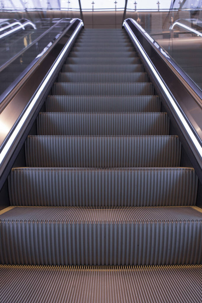 Escalier vide à l'aéroport. Escalier électrique en perspective. Mode de transport : Ascenseur vide dans un immeuble moderne. Escalator dans le métro
.   - Photo, image
