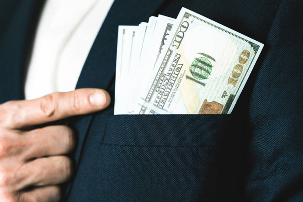 Money success concept. 100 dollar bills in businessman jacket pocket. Symbol of success and wealth. - 写真・画像