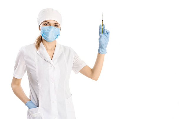 Pretty female doctor wearing white medical robe and holding syringe, health care and pharmacology concept, girl on white uniform. - Foto, afbeelding