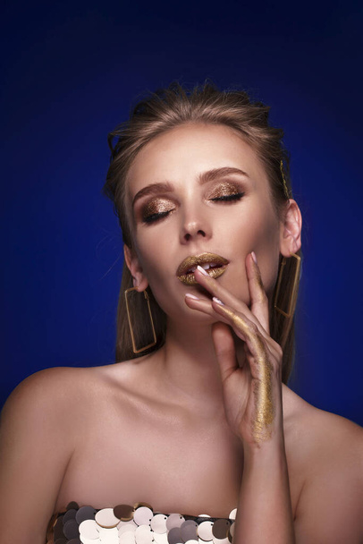 Magic Girl Portrait in Gold. Golden Makeup, close-up portrait in studio shot, color - Fotografie, Obrázek