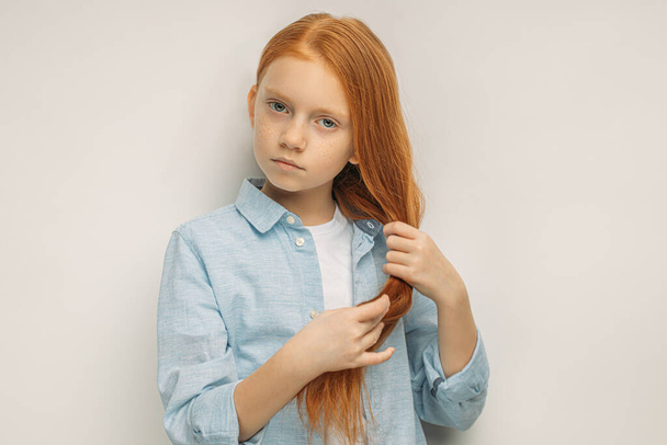portrait of serious caucasian girl with red hair - Fotó, kép