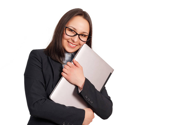 portrait of a smiling business woman in a jacket and glasses, with a laptop in her hands. isolated on a white background. - Foto, imagen