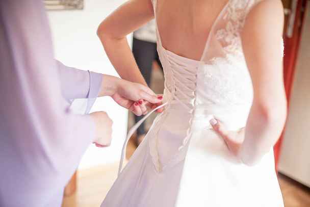 woman helping a bride to dress - Foto, Imagem