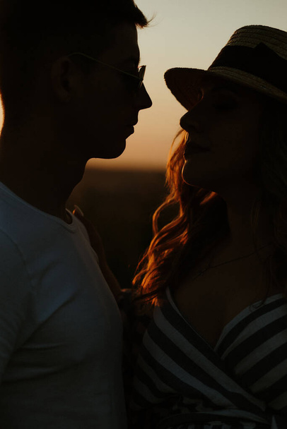 romantic couple at sunset silhouette kiss - Photo, image