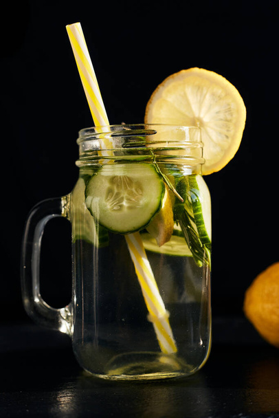 Lemonade on a dark background. Summer refreshing drink - Photo, Image