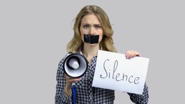 Sad girl with taped mouth cant speak in megaphone. - Séquence, vidéo