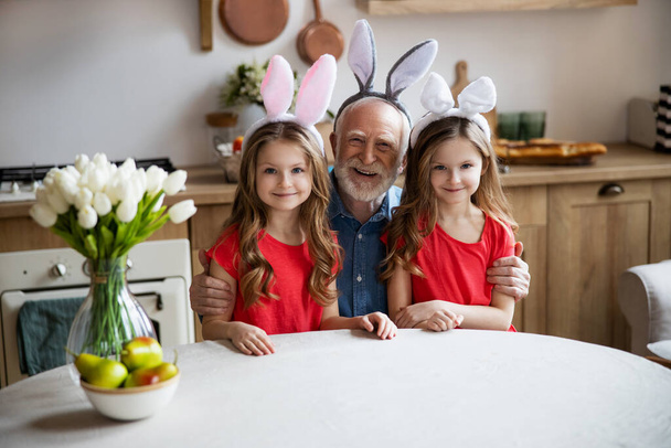 Happy sisters with their grandfather stock photo - Fotoğraf, Görsel