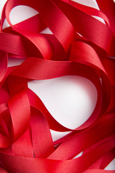 Macro beautiful red curly ribbon textured boarder roll isolated on white background with copy area - Zdjęcie, obraz