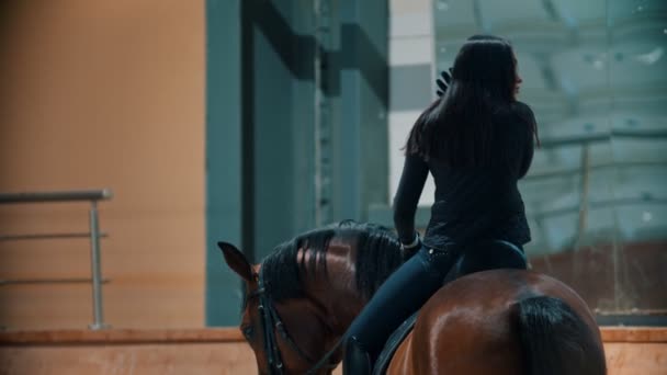 Hippodrome - ratsastaja istuu hevosen selässä ja suoristaa hiuksensa
 - Materiaali, video