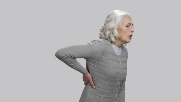 Old lady thin having back pain and toucing it with hand. - Footage, Video