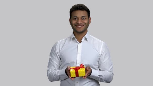 Portrait of happy hindu man giving gift box to you. - Felvétel, videó