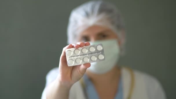Doctor holds pills in his hands. - Video