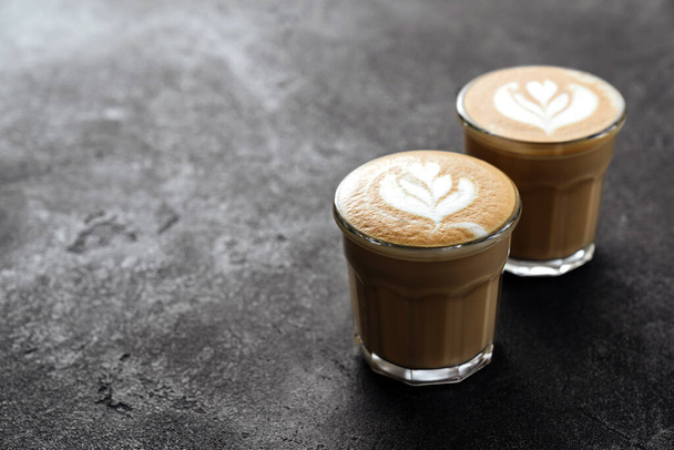 two cups of coffee on black stone background - Zdjęcie, obraz