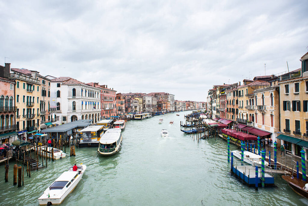 Venice. Italy - May 15, 2019: View from the Rialto Bridge to Grand Canal in Venice. Gondolas and Boats Traffic. - Photo, image