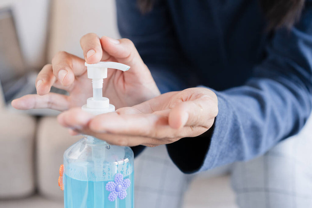 Asian women clean hand with alcohol gel sanitizer prevent the spread of germ and bacteria and avoid virus covid-19 - 写真・画像