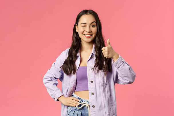 Cheerful good-looking, stylish woman wink and thumb-up as being pleased with service provides, recommend use company product or subscribe, smiling satisfied, pink background - Valokuva, kuva