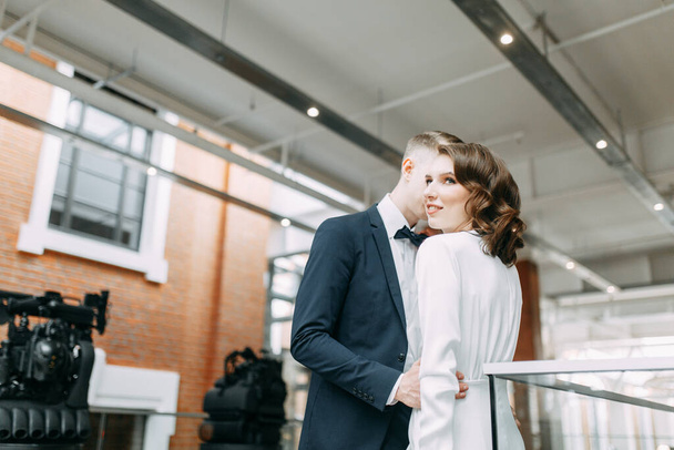 The bride and groom's romantic photo shoot. The newlyweds are happy together. Stylish modern couple in the Museum.  - Foto, Imagen